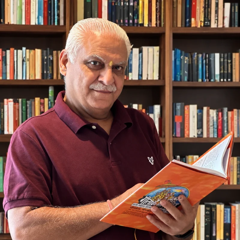 Dr. Rajesh Takyar with a book